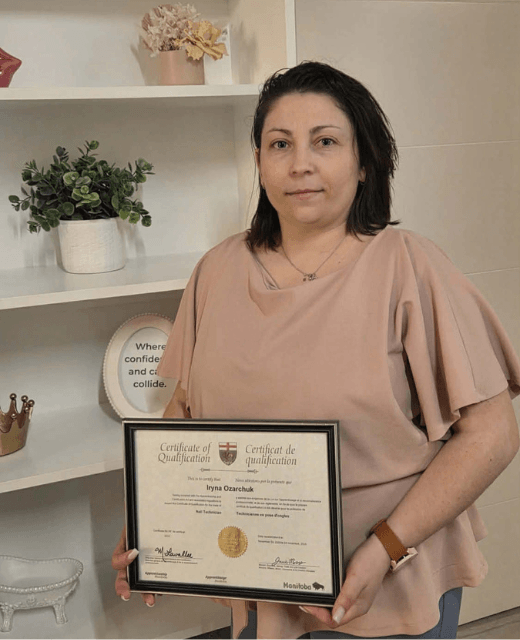 Certified nail technician in Winnipeg holding professional certificate – hygienic nail services